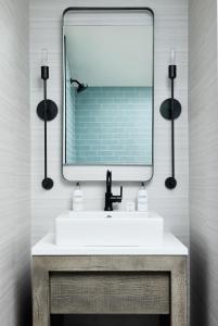 a bathroom with a sink and a large mirror at The Edgartown Inn, The Edgartown Collection in Edgartown