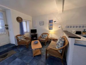 a living room with chairs and a couch and a table at 6CONV21 Maison de pêcheur au Faubourg in Collioure