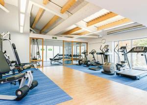 a gym with treadmills elliptical machines and exercise equipment at Cheddar Woods Resort And Spa in Cheddar
