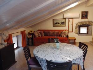 a living room with a table and a couch at Guesthouse Koren in Vipava