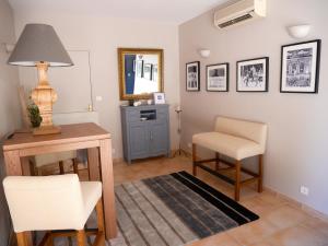 a living room with a desk and chairs and a mirror at Le relais d'Angélique in Lunel