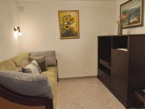 a living room with a couch and a dresser at Guesthouse Koren in Vipava