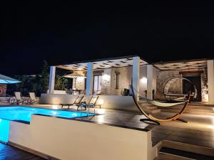 a villa with a swimming pool at night at Kallixeni Villas in Rethymno