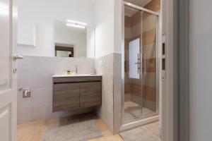 a bathroom with a sink and a shower at Fossi Elegant Apartment in Florence +5 photos