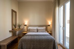 a bedroom with a bed and a large window at Sofias LemonTree Family House in Agios Nikolaos