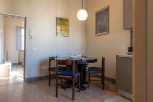 a kitchen and dining room with a table and chairs at Fossi Elegant Apartment in Florence