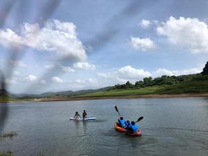 a group of people on a river in a kayak at Randeniya Hena - Kandy in Teldeniya
