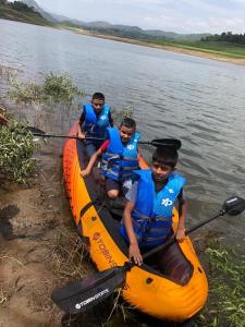 a group of people in a kayak on a river at Randeniya Hena in Teldeniya