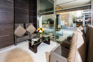 a living room with a couch and a table at Diva Hotel in Manama