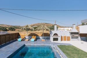 a villa with a swimming pool and a house at Villa Balux in Kalamaki