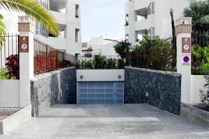a blue garage door in front of a building at Agora 0-3 DELUXE 1B in Palm-mar