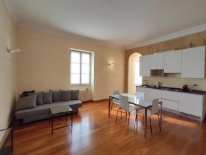 a living room with a couch and a table and chairs at Solferino Apartment 2 in Turin