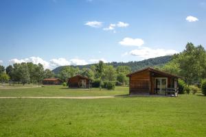 a couple of small buildings in a field at Les Chalets de Condrieu in Condrieu