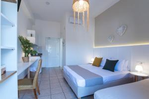 a bedroom with a bed and a table and a chair at Mirage Studios in Malia +89 photos