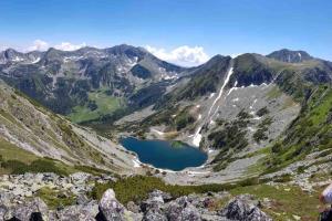 a lake on the side of a mountain at Warm and cozy studio flat near Straja in Uricani