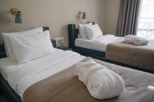Postel nebo postele na pokoji v ubytování RUBEL APARTHOTEL&SPA
