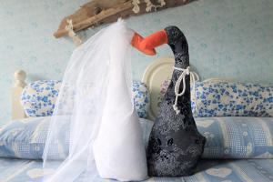 a black and white wedding veil on a bed at The Duck's Cottage in Feltre