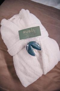 a white towel with a blue object on top of it at RUBEL APARTHOTEL&SPA in Yaremche