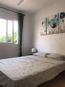 a bedroom with a large bed and a window at Lovely one bedroom unit with balcony and pool in Denia
