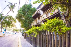 a fence on a street next to a building at Pousada Manga Rosa Beira Mar in Natal