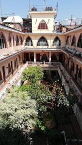 a large building with trees in the courtyard at Hotel Iberia in Córdoba