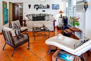 a living room with a couch and chairs at Vieques Island House with Caribbean Views and Pool! in Vieques