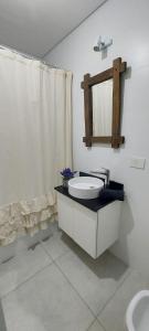 a bathroom with a tub and a sink and a mirror at Espacioso monoambiente en pleno centro in Adrogué