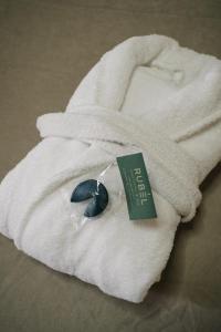 a white towel with a tie and a tag on it at RUBEL APARTHOTEL&SPA in Yaremche