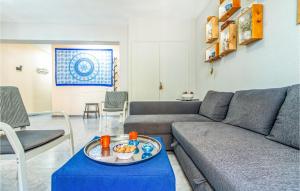 a living room with a couch and a table at Beautiful Apartment In Santa Pola in Santa Pola +13 photos