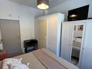 a bedroom with a bed with a tv on top of it at Les Merisiers B&B - Thorenc in Thorenc