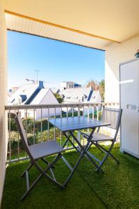a table and chairs on a balcony with a view at LE KERNOGUET in Vannes