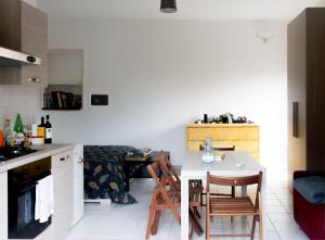 a kitchen with a small table and chairs in a room at 8380 Il Glicine in Albinia