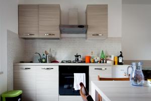 a kitchen with white cabinets and a black oven at 8380 Il Glicine in Albinia