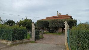 a gate to a house with a fence at 8380 Il Glicine in Albinia