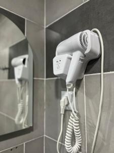 a blow dryer hanging on a wall in a bathroom at Hotel Mountain Mestia in Mestia