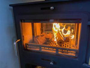 a fireplace with food being cooked in it at Glan Aber Hotel in Betws-y-coed