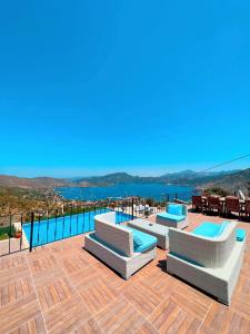 a patio with three lounge chairs and a swimming pool at Selimiye Lime Garden in Selimiye