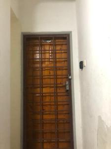 a wooden door in the corner of a room at Putri homestay Seaview pd in Port Dickson