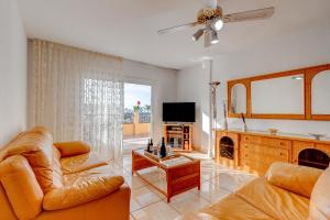een woonkamer met een bank en een tv bij Las Brisas FREE WIFI in Adeje