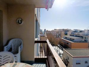 a balcony with chairs and a view of a city at Villa Service - Torre Barot 5º in Calafell