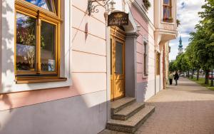 a building on a street with people walking down the sidewalk at Apartmány Sladký sen in Kežmarok