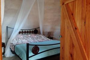 a bedroom with a bed with a canopy at Quinta Terramadome: Dome incomum & responsável in Penamacor