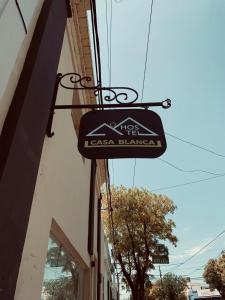 a sign hanging from the side of a building at Hostel Casa Blanca in San Luis