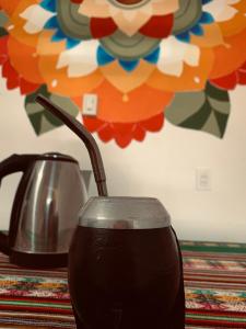 a tea pot and a tea kettle on a table at Hostel Casa Blanca in San Luis