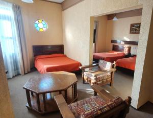 Postel nebo postele na pokoji v ubytování HOTEL POSADA DE LA MONEDA