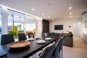 a dining room with a table and some chairs at Golf Palms in Costa Teguise