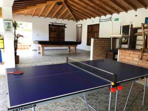 a ping pong table in the middle of a room at Finca la Bonita, Barbosa, Antioquia. in Barbosa