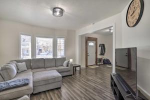 a living room with a couch and a clock on the wall at Pet-Friendly Home Rental Near Notre Dame! in South Bend