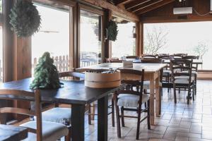a restaurant with tables and chairs and windows at Agriturismo Ponte Di Riocchio in Gubbio