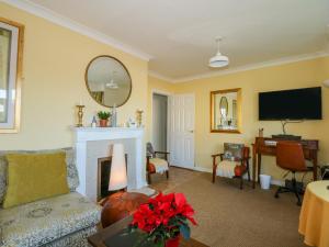 a living room with a fireplace and a tv at See The Sea in Hunstanton